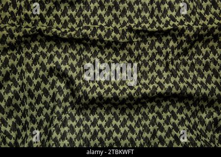 Keffieh Schal. Die Textur des traditionellen Baumwoll-symbolischen arabischen Schals. Khaki Hintergrund. Stockfoto