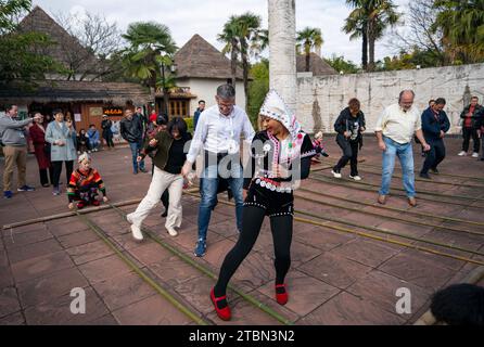 (231208) -- PEKING, 8. Dezember 2023 (Xinhua) -- Teilnehmer lernen Bambustanz im ethnischen Kulturdorf Yunnan in Kunming, südwestchinesische Provinz Yunnan, 7. Dezember 2023. Der 5. World Media Summit (WMS), der von der Nachrichtenagentur Xinhua und den Provinzregierungen von Guangdong und Yunnan gemeinsam veranstaltet wird, findet vom 2. Bis 8. Dezember in den Städten Guangzhou und Kunming statt. An der 5. WMS nahmen über 450 Teilnehmer aus 101 Ländern und Regionen Teil, darunter Vertreter von 197 Massenmedien, Think Tanks, Regierungsbehörden und diplomatischen Vertretungen in China sowie UN-Organisationen und internationalen Organisationen Stockfoto