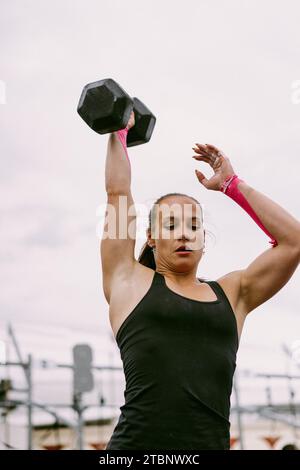 CrossFit-Wettbewerb für Damen. Frau mit Kurzhanteln. Stockfoto