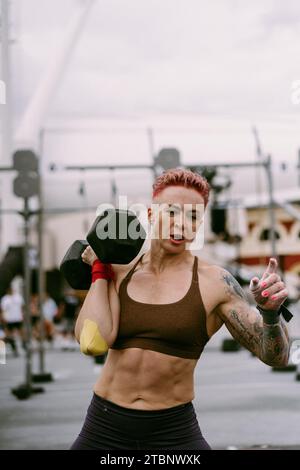 CrossFit-Wettbewerb für Damen. Frau mit Kurzhanteln. Stockfoto