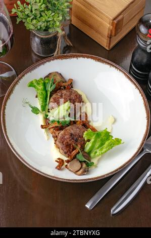 Fleischbällchen auf einem Teller mit Kartoffeln und Gemüse gebraten Stockfoto