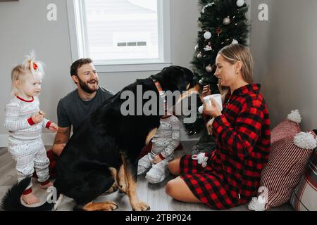 Familie und Hund für Baum mit Kaffee Stockfoto