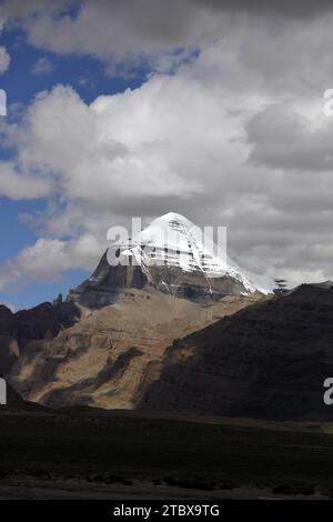 Dieses atemberaubende Foto fängt die unberührte Schönheit der Berge mit einer Himmelskulisse und weißen flauschigen Wolken ein Stockfoto