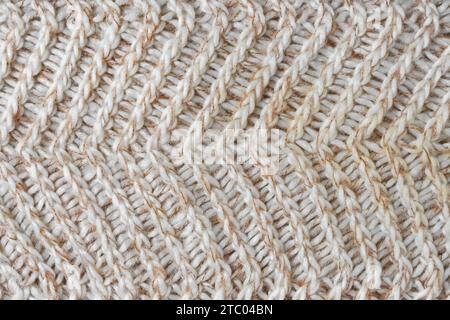 Jersey Textil Hintergrund, beige weiß melierte gestrickte Wolle Stoff. Strickwaren aus Wolle, Pullover, Oberflächenbeschaffenheit des Pullovers, Textilstruktur, Stoffsurf Stockfoto