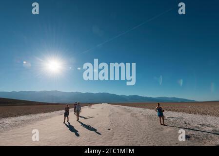 Touristen kehren von der Erkundung der Salzpfanne rund um das Badwater Basin im Death Valley in Kalifornien, USA, zurück Stockfoto