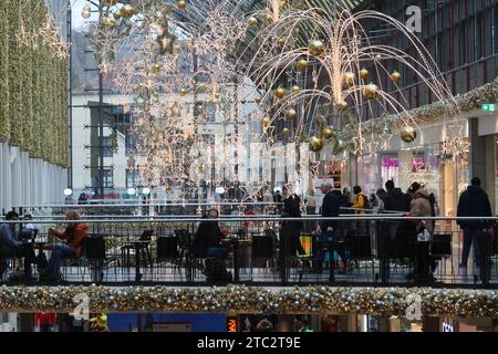 Jena, Deutschland. Dezember 2023. Besucher spazieren durch das Einkaufszentrum „Goethe Galerie“ im Stadtzentrum. Am zweiten Adventssonntag nutzen zahlreiche Menschen die Einkaufsmöglichkeit. Quelle: Bodo Schackow/dpa/Alamy Live News Stockfoto