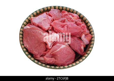 Fleisch auf einem rustikalen Gericht, isoliert auf weißem Hintergrund. Rohes Rindfleisch zum Kochen. Draufsicht. Stockfoto