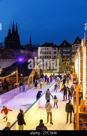 Eislaufbahn auf dem Weihnachtsmarkt am Heumarkt in der historischen Stadt, Blick auf den Dom, Köln, Deutschland. Eislaufbahn auf dem Weihnachts Stockfoto