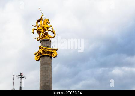 Tiflis, Georgien - 22. September 2023: goldene Statue St. Georg tötet Drachen auf dem Freiheitsdenkmal in Tiflis Stadt am wolkigen Herbst d Stockfoto