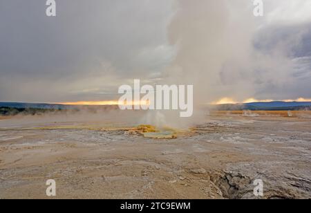 Sonnenuntergang und Wolken von Clepsydra Geysir im Yellowstone National Park in Wyoming Stockfoto