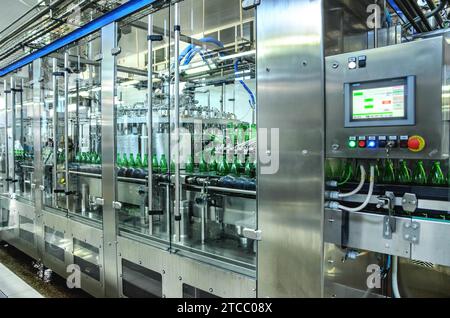 Wassergrüne Abfüllanlage. Industrieller Förderer von Mineralwasser. Prozessausrüstung Stockfoto