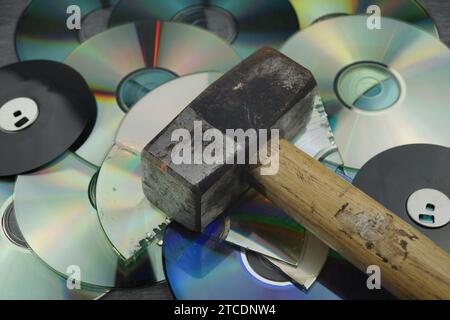 Zerstörte DVDs und Hammer, Symbolbild für Hackerangriffe Stockfoto