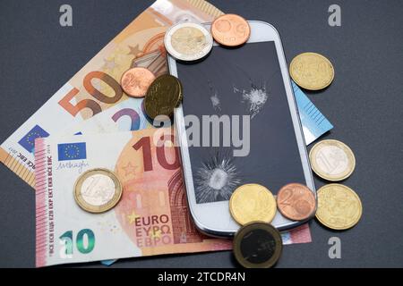 Handy mit defektem Display und Euro, Symbolbildkosten für Handy Stockfoto