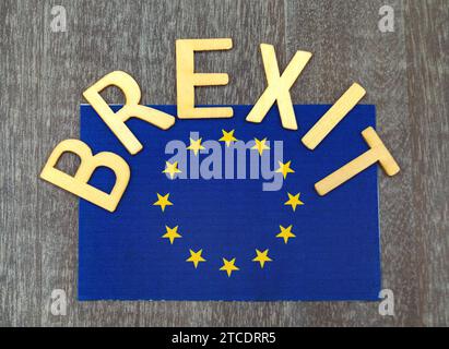 Das Wort Brexit mit EU-Flagge auf grauem Hintergrund Stockfoto