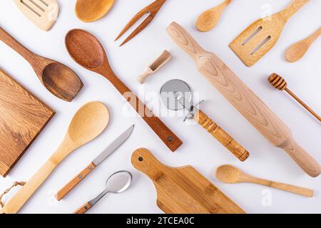 Küchenutensilien aus Holz, Kochutensilien auf weißem Hintergrund. Flaches paralleles diagonales Layout. Küche schöner Hintergrund. Abdeckung. Layout Stockfoto