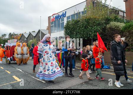 Sunninghill, Großbritannien. November 2023. Es war heute ein geschäftiger Tag auf der Sunninghill Christmas Street Fair in Sunninghill High Street, Ascot, Berkshire. Eine Parade fand statt, darunter die Hampshire Caledonian Pipe Band, lokale Pfadfinder und Guides sowie Schauspieler aus dem lokalen Panto. Dies war die erste Weihnachtsmesse in Sunninghill seit der COVID-19-Pandemie. Kredit: Maureen McLean/Alamy Stockfoto