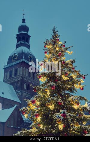 Geschmückter Weihnachtsbaum am Domplatz in der Altstadt von Riga, Rigaer Dom im Hintergrund. Riga, Lettland. Stockfoto
