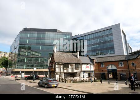 Der Queens Head Pub aus dem 15. Jahrhundert wird von den umliegenden Büroblocks im Stadtzentrum im Schatten gehalten. Stockfoto