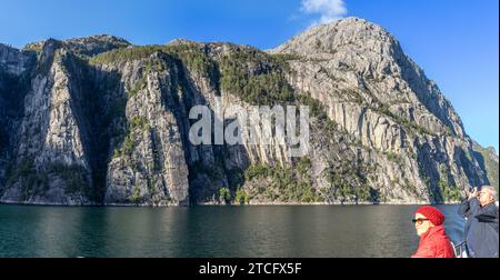 DOS personas desde la cubierta de un barco disfrutan del paisaje en el Fiordo de la Luz o Lysefjord, Stavanger, Noruega Stockfoto