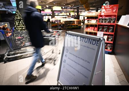 Konstanz Am Bodensee, Deutschland. Dezember 2023. Ein Mann schiebt seinen Einkaufswagen in den Supermarkt, während ein Schild im Vordergrund auf die ruhige Stunde in Edeka hinweist. Quelle: Felix Kästle/dpa/Alamy Live News Stockfoto