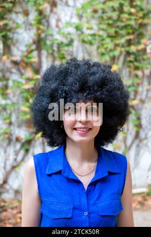 Porträt eines niedlichen multiethnischen Mädchens in einem blauen schulterfreien Kleid. Stockfoto