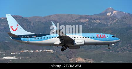 Teneriffa, Spanien, 9. Dezember 2023. Boeing 737-8K5 TUI Airlines fliegt im blauen Himmel. Landet am Flughafen Teneriffa. Der Vulkan El Teide im Hintergrund Stockfoto