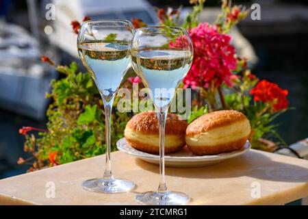 Trinken von französischem Brut-Champagner, Sekt mit süßem Apfel-Beignet-Kuchen, Clubparty im Yachthafen Port Grimaud bei Saint-Tropez, Französisch Stockfoto