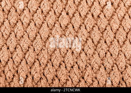 Textur aus Wollgestrick für Tapeten mit Pfirsichfuzzfarbe des Jahres 2024 Stockfoto