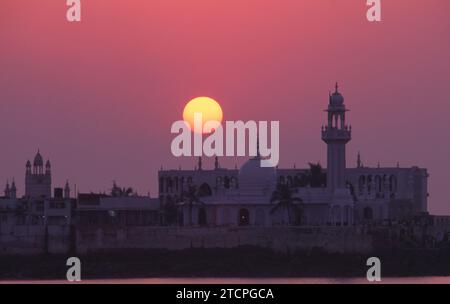 Indien: Sonnenuntergang in der Haji Ali Moschee und Dargah, Worli Bay, Mumbai. Der Dargah ist in das Meer gebaut und beherbergt das Grab des heiligen PIR Haji Ali Shah Buchari. Der Dargah wurde 1431 gebaut. Stockfoto