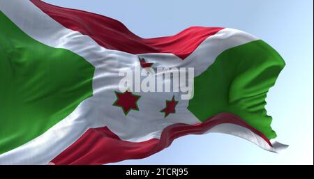 Die Nationalflagge von Burundi winkt an klaren Tagen. Weißes diagonales Kreuz, unterteilt in rote und grüne Abschnitte, drei grüne Sterne in der Mitte. 3D illustr Stockfoto