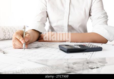 Ingenieurin entwirft architektonische Pläne am Schreibtisch Stockfoto