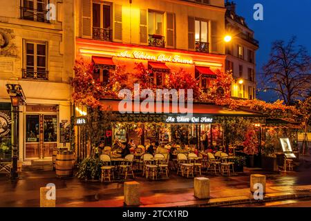 Die Gäste sitzen auf der Außenterrasse und genießen einen Abend im Au Chien qui Fume in der Rue du Pont Neuf im Pariser Stadtteil Halles Stockfoto