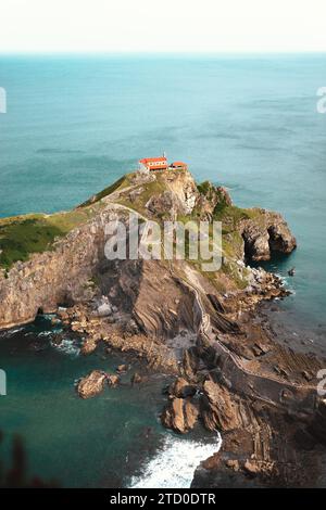 Von oben auf der felsigen Insel mit grünem Gras umgeben von türkisfarbenem Meer in Pais Vasco Spanien Stockfoto
