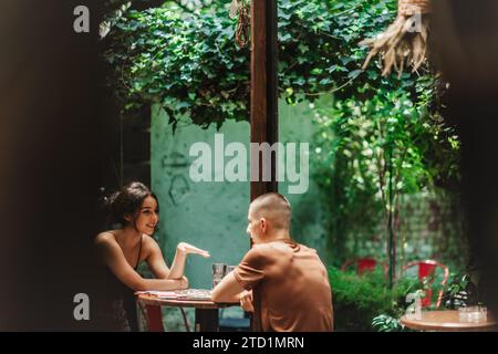 Highschool-Schüler treffen sich in einem Café, diskutieren und helfen einander bei den Hausaufgaben. Genießen Sie Freizeit und Networking online. Stockfoto