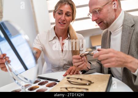 Augenoptiker und Brillenträger in einem Optikgeschäft Stockfoto
