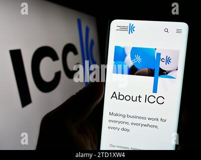 Person, die ein Mobiltelefon hält, mit der Webseite der Internationalen Handelskammer (ICC) vor dem Logo. Konzentrieren Sie sich auf die Mitte des Telefondisplays. Stockfoto