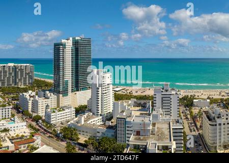 Tourismusinfrastruktur im Süden der USA. South Beach Sandfläche mit Touristen, die sich in der heißen Sonne Floridas entspannen. Miami Beach City mit Luxushotels Stockfoto