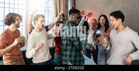 Multiethnische junge Freunde, die zusammen eine Party feiern - lustige, vielfältige Leute, die während einer coolen Party im Wohnzimmer tanzen und singen - Sie Stockfoto