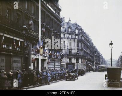 Paris (IInd arr.), Frankreich Dekorationen Avenue de l'Opéra für den 9. Kongress der Amerikanischen Legion, Wirtschaftsaktivität, Kleidung, Transport, Registrierung, Informationen, erster Weltkrieg, Gesellschaft, Boutique, Geschäft, Militäruniform, Automobiltransport, Auto, Menschenmenge, kommerzielle Aufschrift, Gedenkfeier, Konferenz, Kongress, amerikanische Intervention, Flagge, Army, France, Paris, Paris für den Empfang der Amerikanischen Legion dekoriert: Avenue de l'Opéra, Arrondissement II, Etats-Unis [in Verbindung mit], 19/09/1927 - 19/09/1927, Léon, Auguste, Fotograf, Autochrome, Foto, Glas, Autochrome, Foto Stockfoto