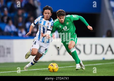 San Sebastian, Guipuzcoa, Spanien. 17. Dezember 2023. Takefusa Kubo von Real Sociedad duelliert um den Ball mit EZ ABde von Real Betis während des LaLiga EA Sports Matches zwischen Real Sociedad und Real Betis im reale Arena Stadium. Quelle: Cesar Ortiz Gonzalez/Alamy Live News Stockfoto