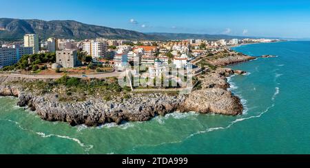 Küstenpanorama von Oropesa del Mar, Spanien, mit blauem Wasser, Klippen, Torreon del Rey, Wachturm und Leuchtturm Stockfoto