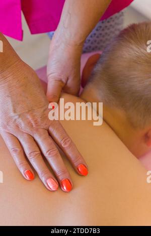 Naturheilkundliche Massagesitzung in einem Naturtherapiestudio. Der Therapeut setzt ganzheitliche Techniken ein, um Entspannung und Wohlbefinden zu fördern. Stockfoto