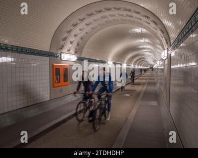 Allgemeine Sicht auf Radfahrer und Fußgänger im Alten Elbtunnel, einem Fußgänger- und Fahrzeugtunnel unter der Elbe in Hamburg. Stockfoto