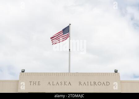 Anchorage Railway Depot-Schild mit Sternenfahne und Streifenfahne, Anchorage, Alaska, USA Stockfoto