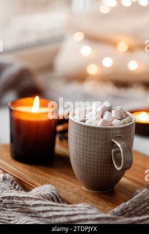 Warme, gemütliche Fensteranordnung, Winter- oder Herbstkonzept, Kaffee, Kerzen werfen Lichter Stockfoto