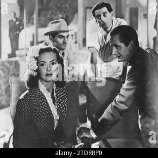 Patricia Roc, Bonar Colleano, Charles Goldner und Nino Martini spielen in One Night With You (1948), einer musikalischen Romantik. Der Film erzählt die Geschichte eines italienischen Sängers, gespielt von Martini, der sich in eine Reihe komödiantischer Verwechslungen und romantischer Begegnungen in London verstrickt sieht, unter anderem mit Rocs Charakter. Dieser charmante und unbeschwerte Film zeigt die Talente seiner Besetzung und verbindet Musik, Humor und Romantik in einem wunderbaren Kinoerlebnis der Nachkriegszeit. Stockfoto