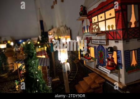 PRODUKTION - 05. Dezember 2023, Bayern, Coburg: Ein Weihnachtsmuseum im Miniaturformat präsentiert weihnachtliches Kunsthandwerk aus dem Erzgebirge, Dresden und anderen Regionen. Rund 20 Meter vom Coburger Marktplatz entfernt, hat Horst Gründel, ausgebildeter Sozialarbeiter und jetzt Rentner, ein einzigartiges, detailreiches Winterwunderland geschaffen. In einem Raum in seiner Wohnung befindet sich ein kleiner Weihnachtsmarkt mit einer Größe von etwa acht Quadratmetern. Über 30 Stände, eine Modelleisenbahn, vier Krippen, eine Gondel, ein Karussell und vieles mehr beleben die Landschaft. Gründel fing an, den ersten zu machen Stockfoto