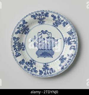 Schüssel mit kannelierten Seiten, Blumenkorb und Blumensprays, anonym, ca. 1700 - ca. 1724 Untertasse aus Porzellan mit gerippter Wand und gelapptem Rand, in Unterglasblau lackiert. Auf der Ebene ein Blumenkorb mit Chrysantheme, Pfingstrose, prunus und Lotus und zwei artemisia-Blättern; die Wand mit Blumenzweigen; am Rand eine Schattenbindung; drei Blumenzweige auf der Rückseite. Auf der Unterseite mit einem artemisia-Blatt in einem Doppelkreis markiert. Blau Weiß. Porzellan. Glasur. Kobalt-(Mineral-)Malerei / Glasur Untertasse aus Porzellan mit geriffelter Wand und gelapptem Rand, in Unterlazeblau lackiert. Auf der Wohnung ein fl Stockfoto