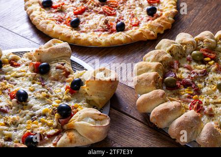 Köstliches Trio: Klassische Pizza, vulkanischer Stil und gefüllte Kruste. Stockfoto