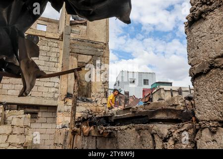 Manila, Philippinen. Dezember 2023. Ein Bewohner wird gesehen, als er am 20. Dezember 2023 nach einem Brand in einem Slumgebiet in Manila, den Philippinen, in die verkohlten Häuser zurückkehrt. Quelle: Rouelle Umali/Xinhua/Alamy Live News Stockfoto